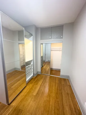 a room with wooden floor and white walls