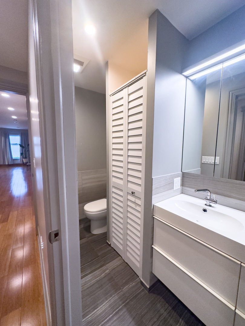 3714 South Indiana Avenue, Unit 2 Chicago, IL 60653 - Photo 17 of 18 a bathroom with a sink a toilet and shower
