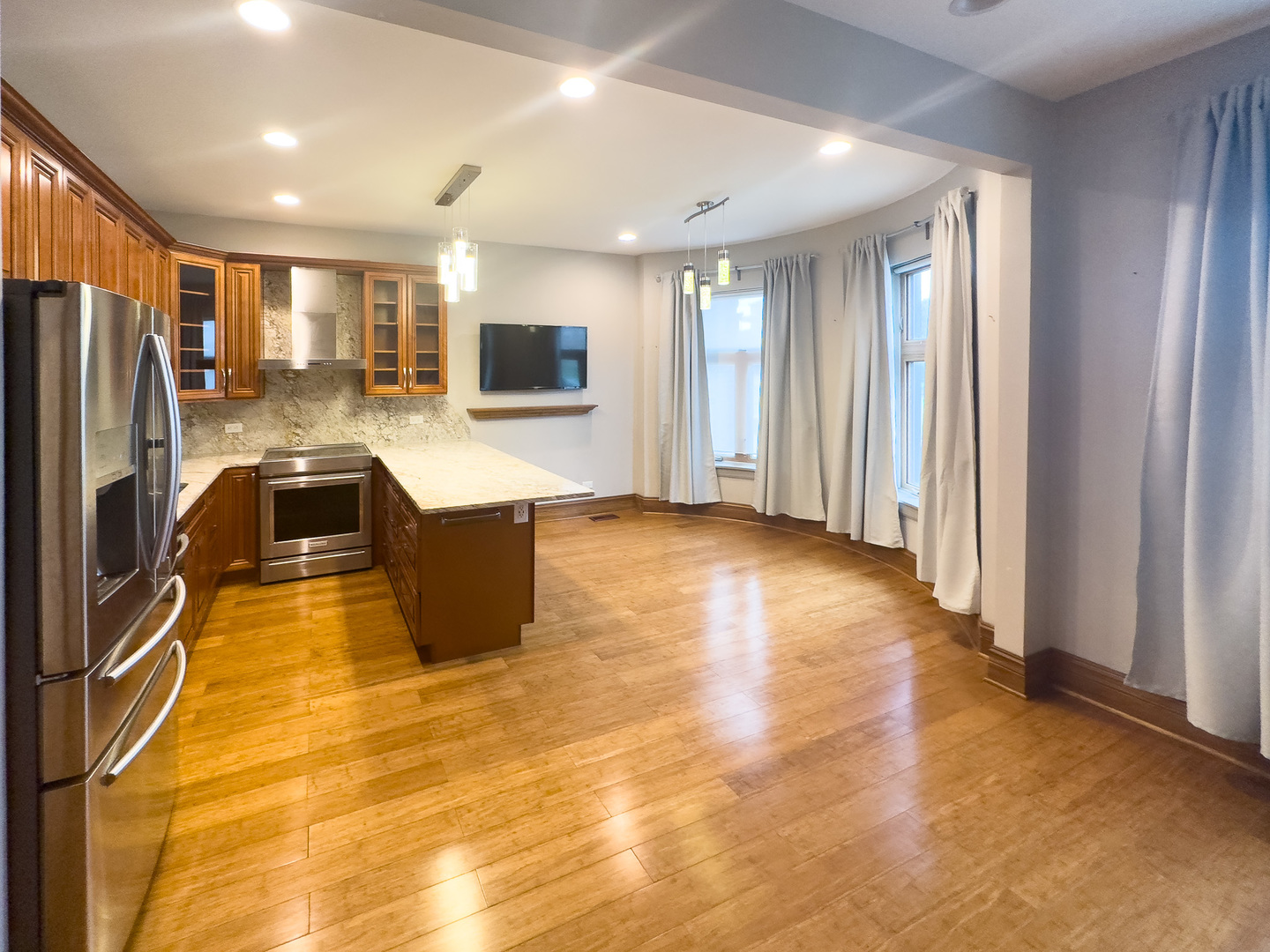 3714 South Indiana Avenue, Unit 2 Chicago, IL 60653 - Photo 2 of 18 a kitchen with stainless steel appliances granite countertop a refrigerator and a sink