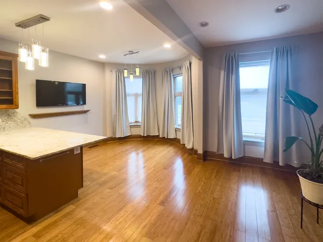 a view of workspace with wooden floor and windows