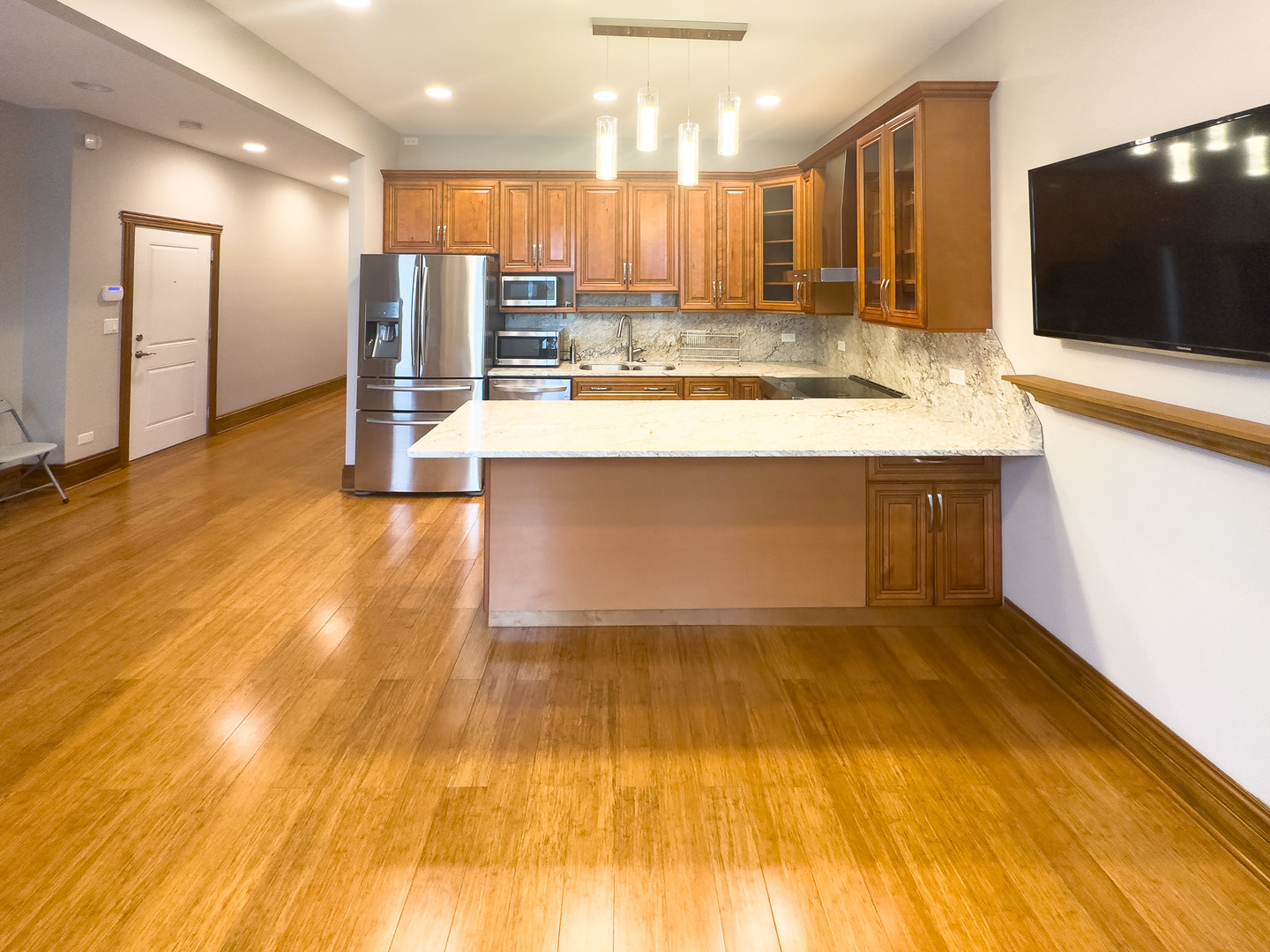 3714 South Indiana Avenue, Unit 2 Chicago, IL 60653 - Photo 5 of 18 a view of kitchen with kitchen island a sink and a large refrigerator