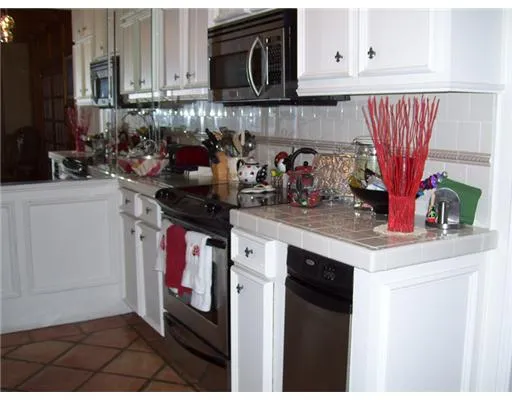 a kitchen with stainless steel appliances granite countertop a sink dishwasher stove and cabinets