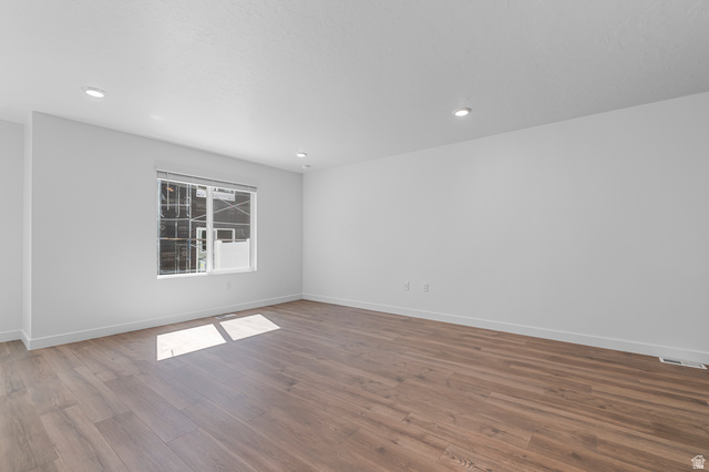 1907 East 640th North, Unit 1225 Salem, UT 84653 - Photo 17 of 20 Expansive room featuring wood-finish flooring, white walls, and recessed lighting