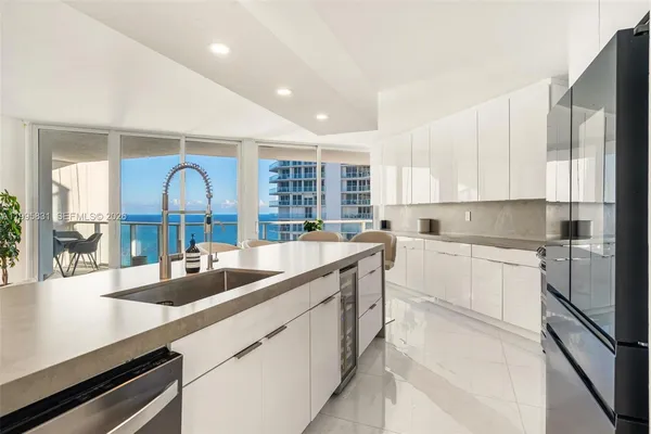 a kitchen with stainless steel appliances a sink a stove and cabinets