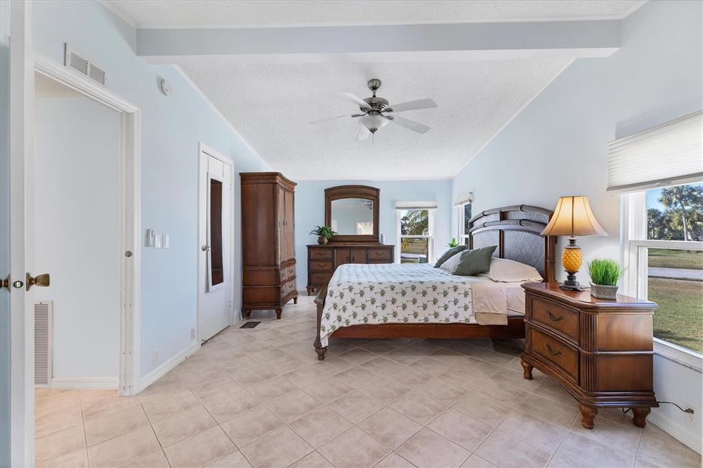 159 Osprey Circle Ellenton, FL 34222 - Photo 12 of 37 a spacious bedroom with a bed and a chandelier