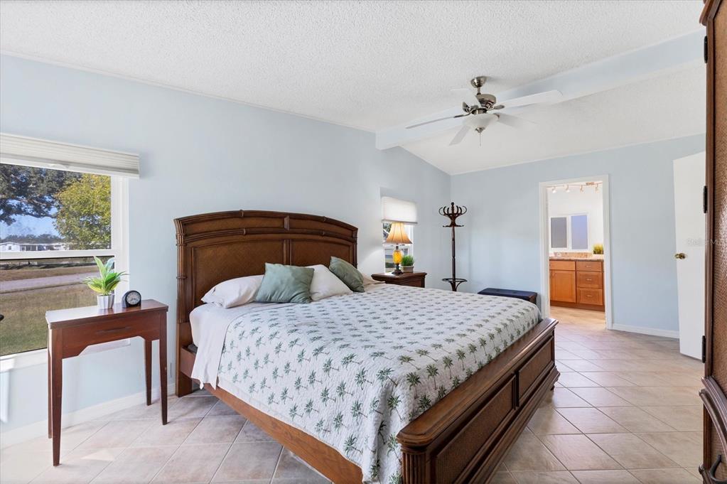 159 Osprey Circle Ellenton, FL 34222 - Photo 13 of 37 a bedroom with a bed and a chandelier