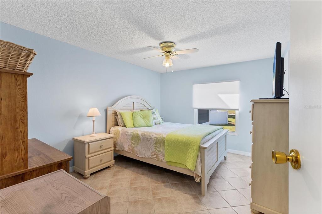 159 Osprey Circle Ellenton, FL 34222 - Photo 15 of 37 a bedroom with a bed and a chandelier
