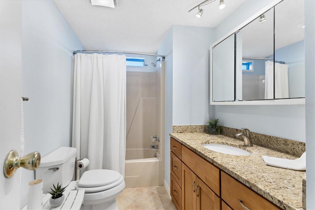159 Osprey Circle Ellenton, FL 34222 - Photo 16 of 37 a bathroom with a granite countertop sink a toilet and shower
