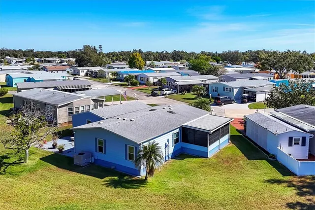 a aerial view of residential houses with yard