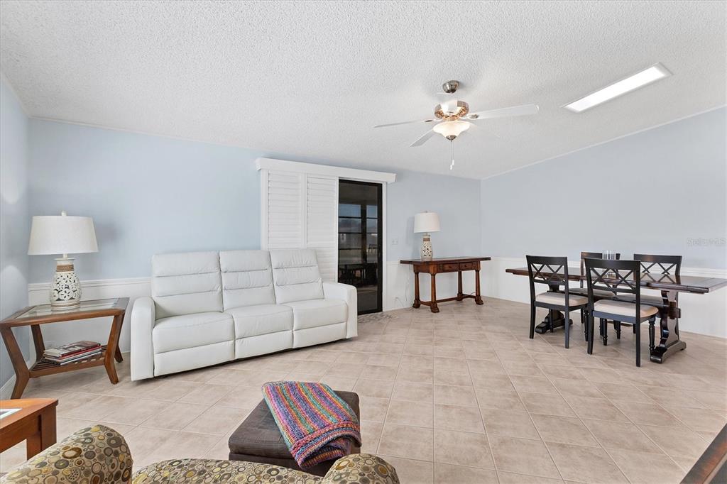 159 Osprey Circle Ellenton, FL 34222 - Photo 4 of 37 a living room with furniture and a dining table with kitchen view