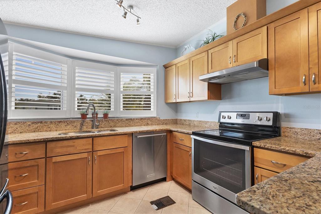 159 Osprey Circle Ellenton, FL 34222 - Photo 6 of 37 a kitchen with stainless steel appliances granite countertop a sink stove and cabinets