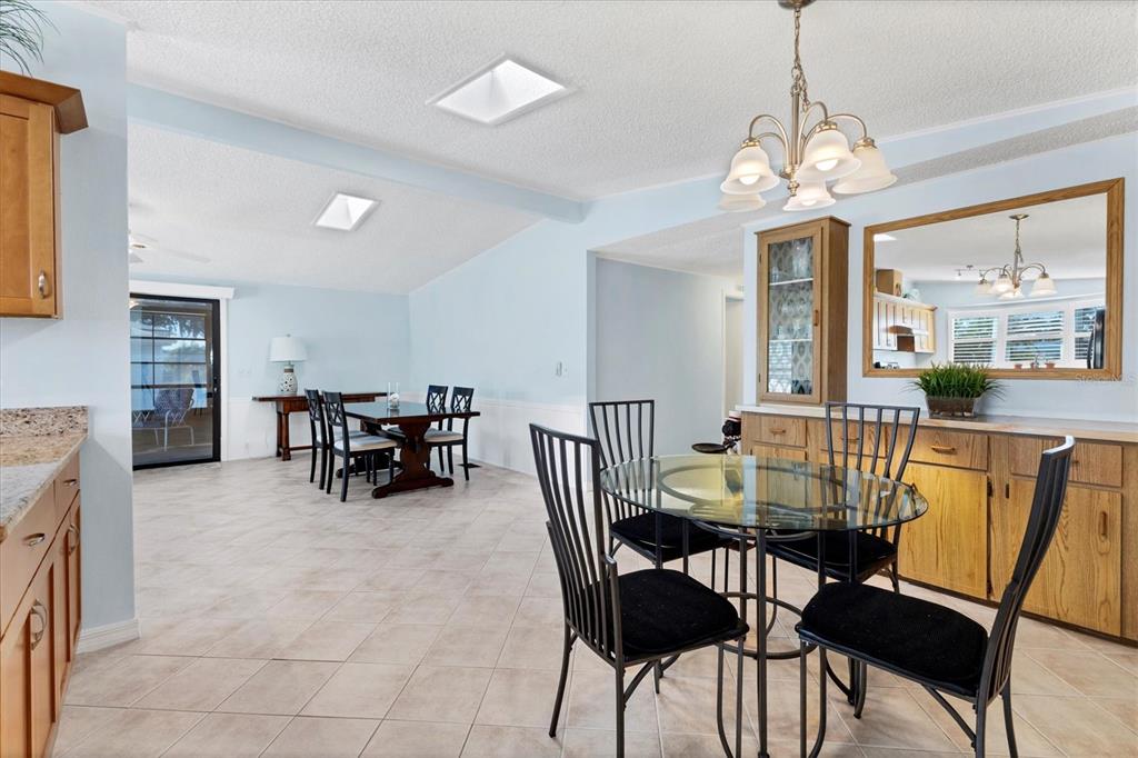 159 Osprey Circle Ellenton, FL 34222 - Photo 9 of 37 a view of a dining room with furniture a chandelier and a large window