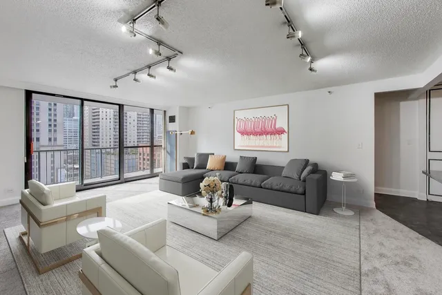 a living room with furniture a flat screen tv and a large window