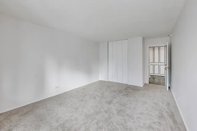 a view of an empty room and closet area