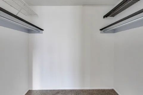 a bathroom with a granite countertop sink mirror and a toilet