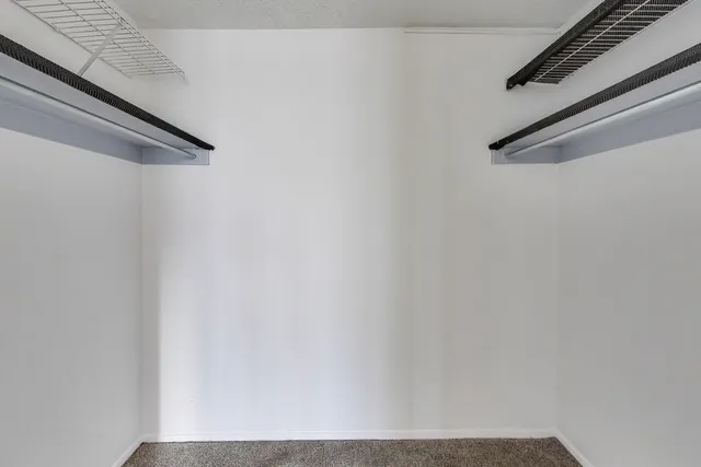 a bathroom with a granite countertop sink mirror and a toilet