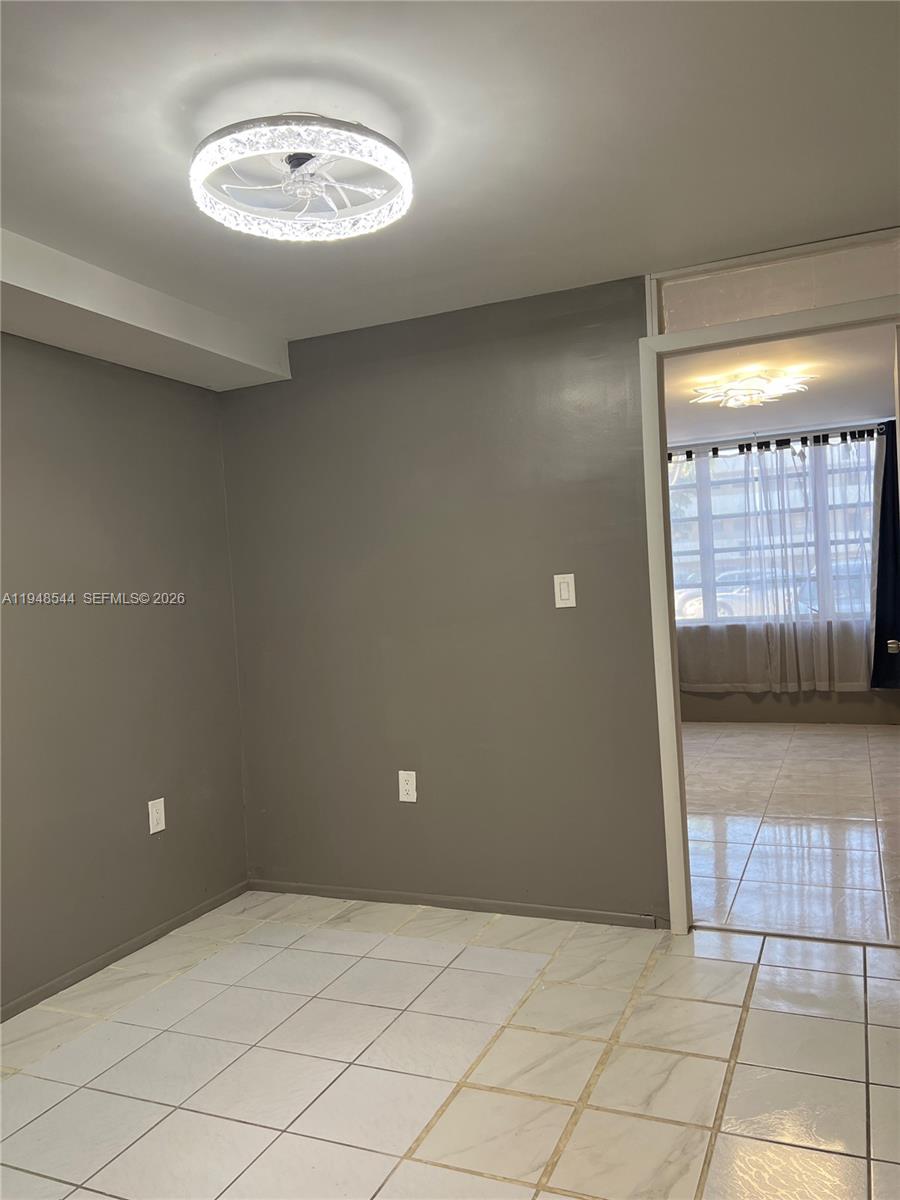 1710 Northeast 191st Street, Unit 1003 Miami, FL 33179 - Photo 11 of 16 a view of an empty room with a window
