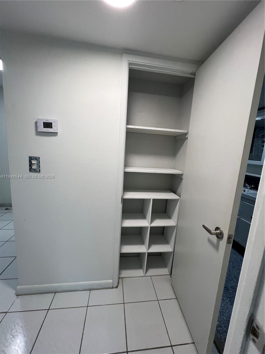 1710 Northeast 191st Street, Unit 1003 Miami, FL 33179 - Photo 13 of 16 a view of an empty walk in closet
