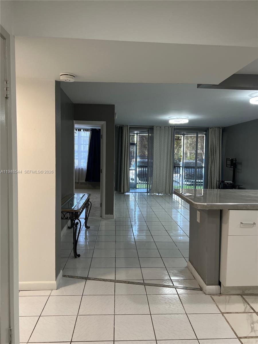 1710 Northeast 191st Street, Unit 1003 Miami, FL 33179 - Photo 2 of 16 a lobby with a chair and mirror