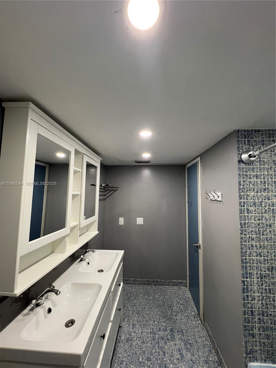 1710 Northeast 191st Street, Unit 1003 Miami, FL 33179 - Photo 4 of 16 a bathroom with a sink and a mirror