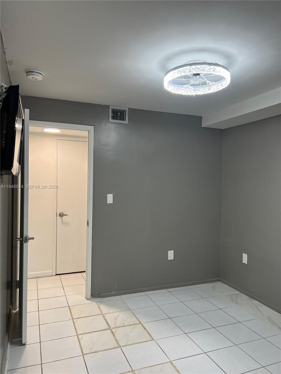 1710 Northeast 191st Street, Unit 1003 Miami, FL 33179 - Photo 10 of 16 en empty room with windows