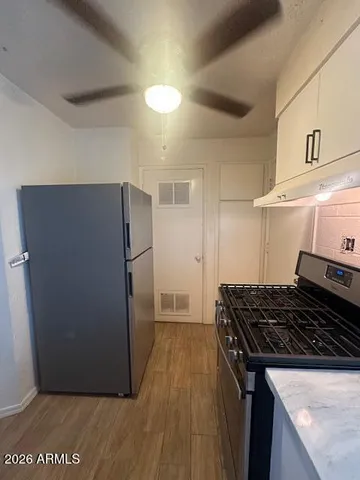 a kitchen with a refrigerator and a stove
