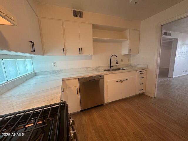 1101 East Bethany Home Road, Unit 16 Phoenix, AZ 85014 - Photo 7 of 15 a kitchen with a sink cabinets and wooden floor