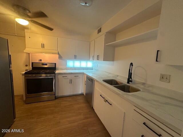 1101 East Bethany Home Road, Unit 16 Phoenix, AZ 85014 - Photo 8 of 15 a kitchen with granite countertop a sink and white cabinets