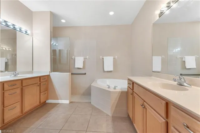 a bathroom with a tub sink and mirror