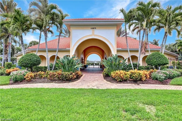 a view of a pathway with plants and flowers