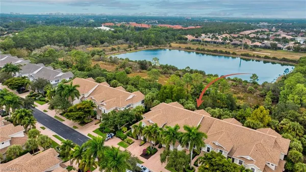 an aerial view of residential houses with outdoor space and lake view