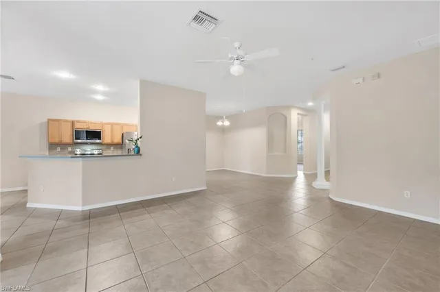 a view of a kitchen with a microwave and cabinets
