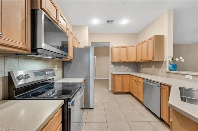 a kitchen with a stove a sink and a refrigerator