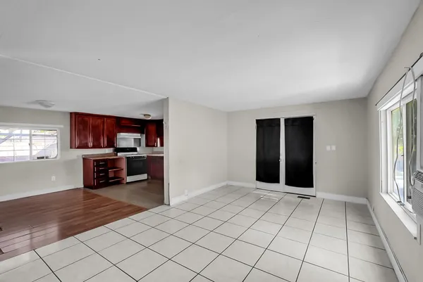 an empty room with windows and closet