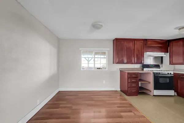 a view of a kitchen with a sink stove and a window