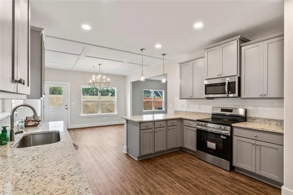 a kitchen with stainless steel appliances granite countertop a sink and stove top oven