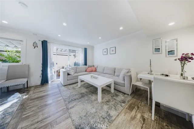 a living room with lots of furniture and wooden floor