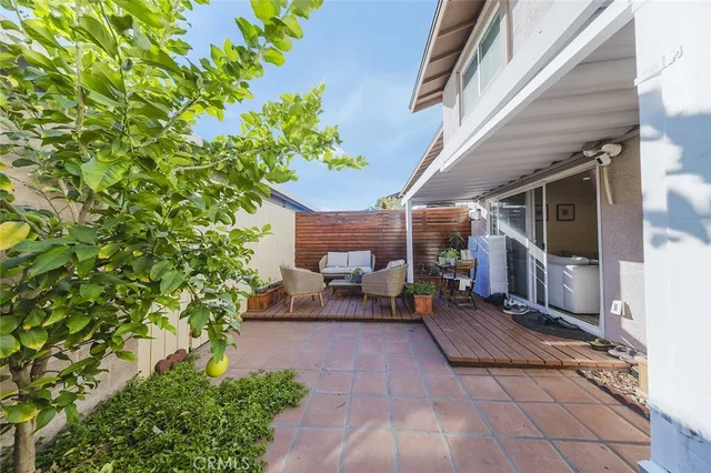 a balcony with wooden floor and furniture