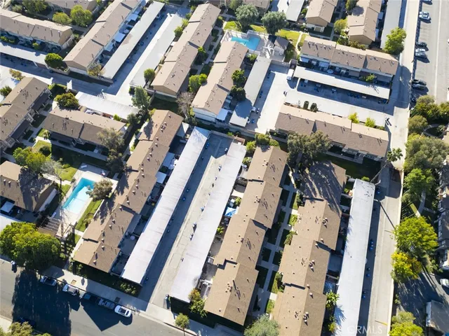 an aerial view of a residential houses with yard and swimming pool
