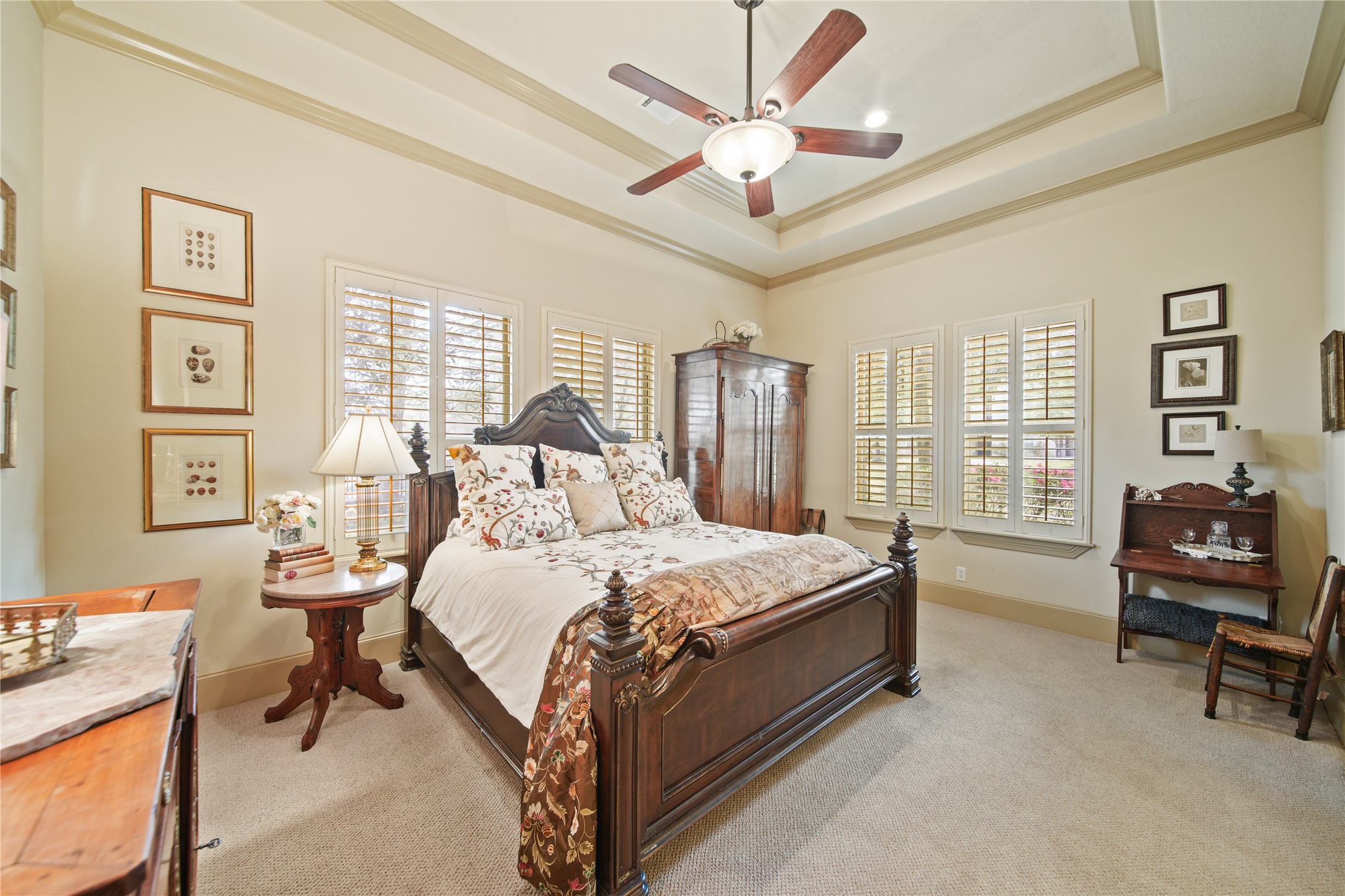 6702 Star Ledge Court Spring, TX 77389 - Photo 19 of 46 a spacious bedroom with a bed a couch and a chandelier