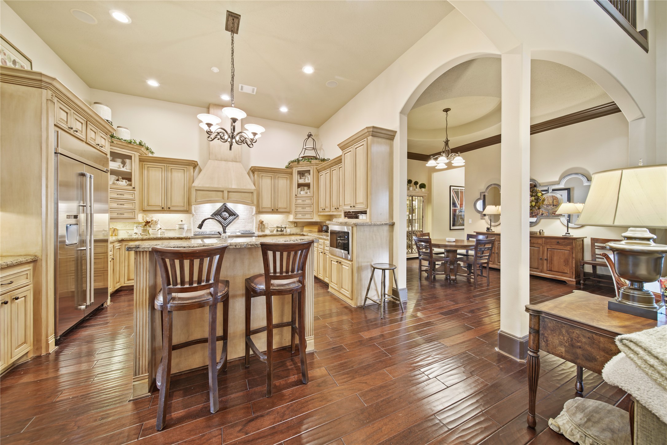 6702 Star Ledge Court Spring, TX 77389 - Photo 10 of 46 a view of a a dining room and livingroom with furniture wooden floor a chandelier