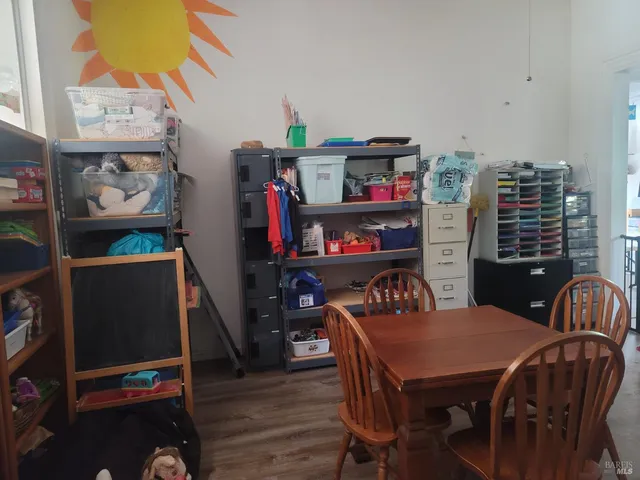 a dining room with furniture and wooden floor