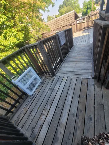 a front view of a house with a tree