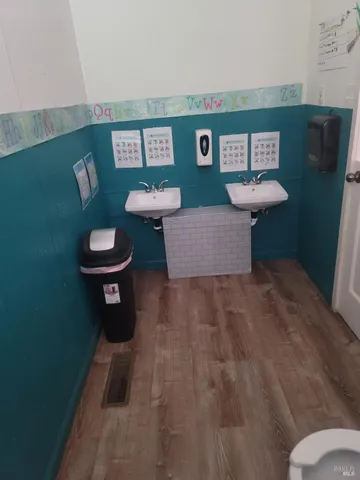 a patio with table and chairs and potted plants