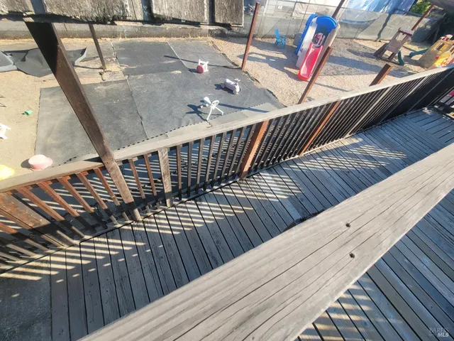 a backyard of a house with trees and outdoor seating