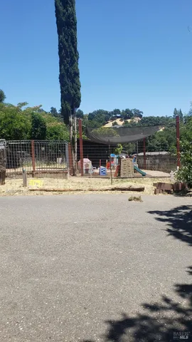 a room with stainless steel appliances kitchen island granite countertop furniture and a couch