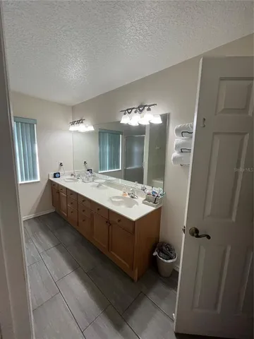 a bathroom with a double vanity sink and mirror