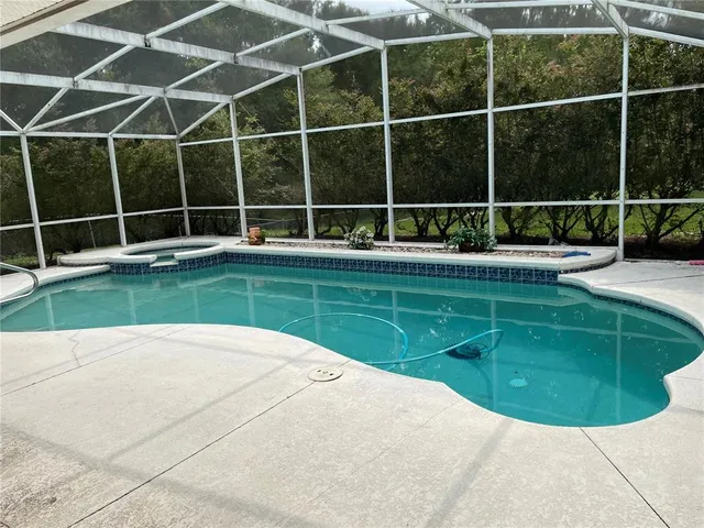 a view of a backyard with swimming pool