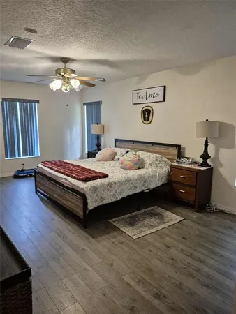 a bedroom with a bed and a chandelier