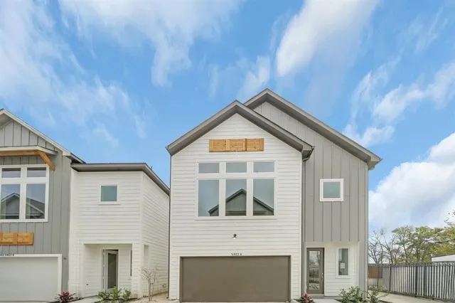 a living room with lots of furniture and kitchen view